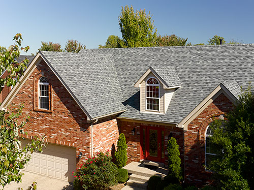 Top view of a roof made of asphalt shingles on a large house
