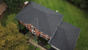 Top view of an asphalt shingle roof on a large family home