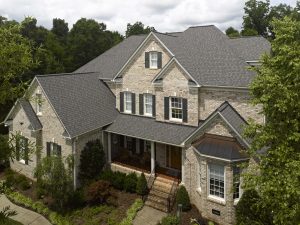Gray-colored shingle roofing system on a luxurious home