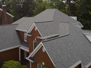 Light gray-colored asphalt shingles on a large colonial home