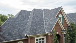 Close-up view of a gray slate roof on a brick house